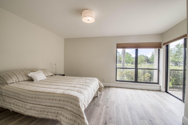 6 E Lexington Ln Unit C, Palm Beach Gardens, FL 33418 - bedroom featuring wood finished floors, access to exterior, and baseboards