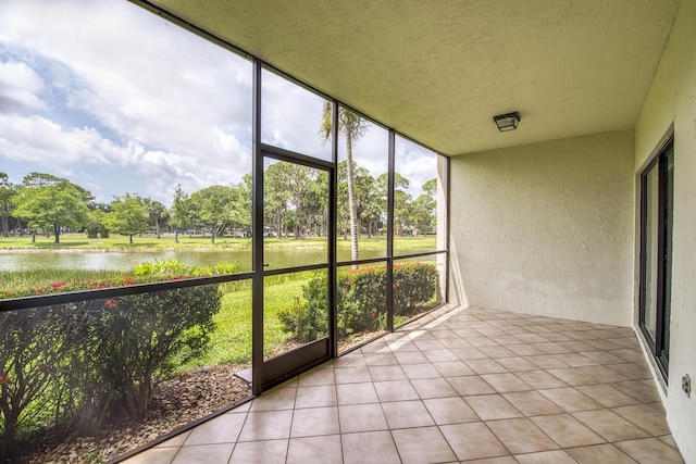 6 E Lexington Ln Unit C, Palm Beach Gardens, FL 33418 - unfurnished sunroom featuring a water view, view of scattered trees, and healthy amount of natural light