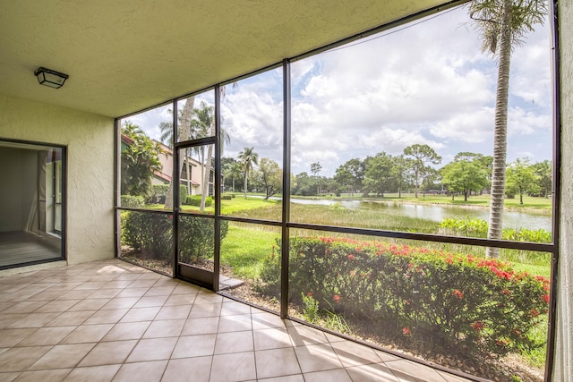 6 E Lexington Ln Unit C, Palm Beach Gardens, FL 33418 - unfurnished sunroom featuring a water view and view of wooded area