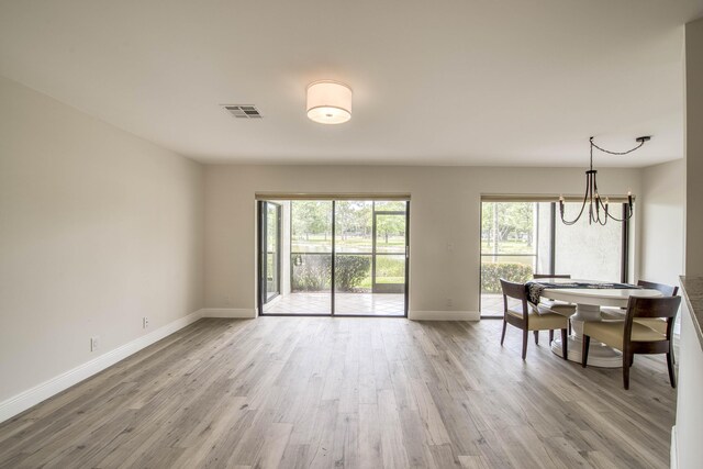 6 E Lexington Ln Unit C, Palm Beach Gardens, FL 33418 - dining area featuring baseboards, wood finished floors, and a chandelier