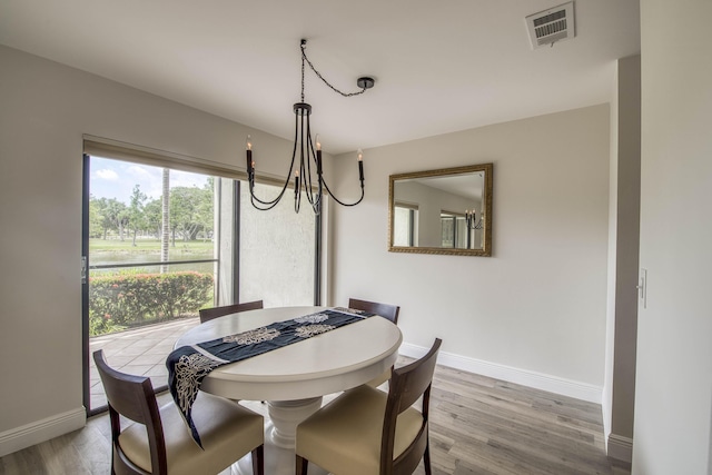 6 E Lexington Ln Unit C, Palm Beach Gardens, FL 33418 - dining area with a chandelier, baseboards, and wood finished floors