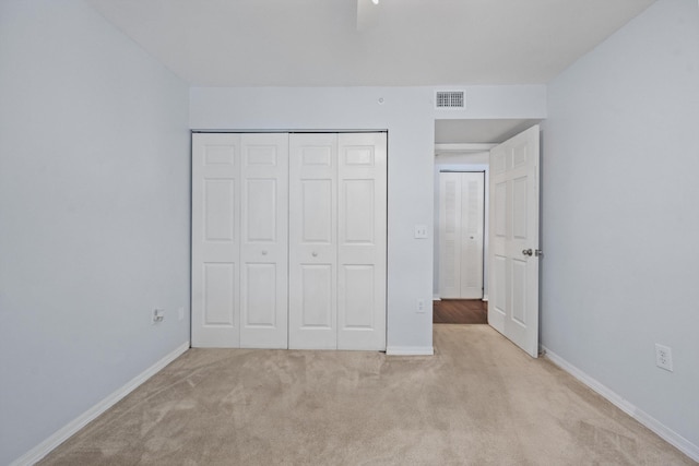 4179 N Haverhill Rd Unit 609, West Palm Beach, FL 33417 - unfurnished bedroom featuring light colored carpet, a closet, baseboards, and a ceiling fan