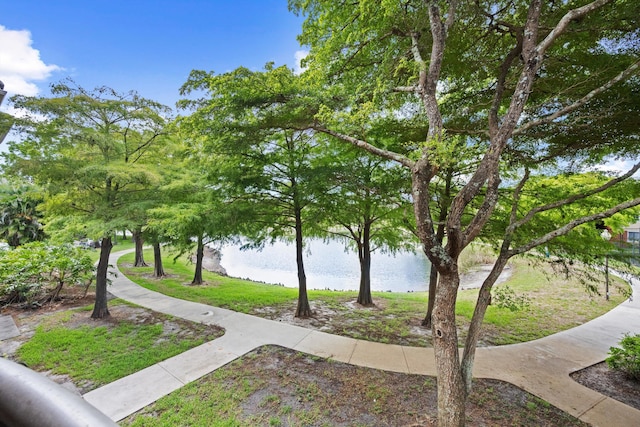 4179 N Haverhill Rd Unit 609, West Palm Beach, FL 33417 - surrounding community featuring a water view and a lawn