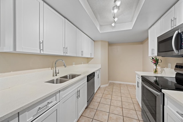 4179 N Haverhill Rd Unit 609, West Palm Beach, FL 33417 - kitchen with appliances with stainless steel finishes, a sink, a raised ceiling, a textured ceiling, and light countertops