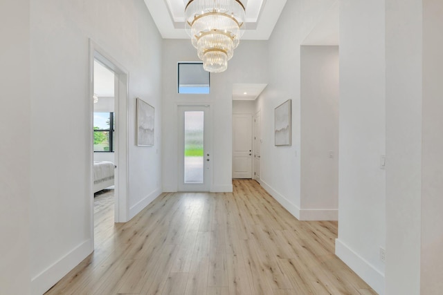 17135 SW Ambrose Way, Port Saint Lucie, FL 34986 - entrance foyer with a chandelier, light wood-type flooring, and a towering ceiling