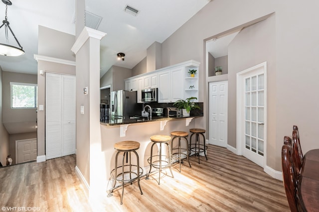 805 Harbour Pointe Way, Greenacres, FL 33413 - kitchen featuring stainless steel appliances, light wood-style flooring, open shelves, decorative backsplash, and vaulted ceiling