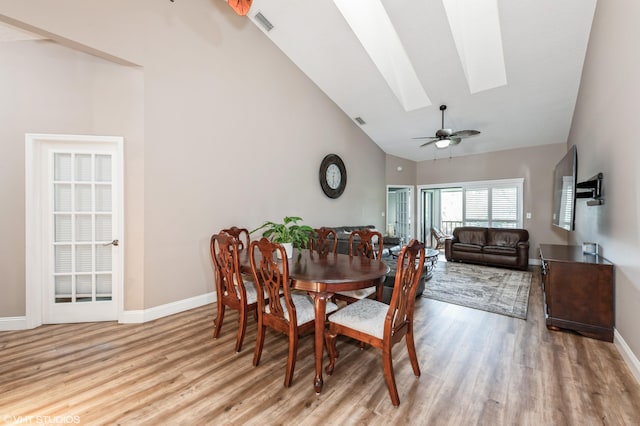 805 Harbour Pointe Way, Greenacres, FL 33413 - dining space with a skylight, light wood-style floors, high vaulted ceiling, baseboards, and a ceiling fan