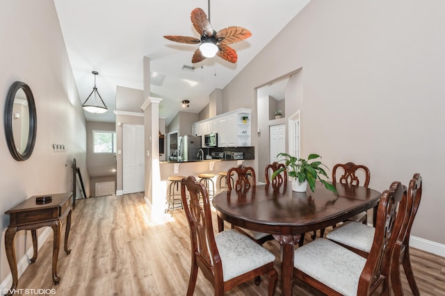 805 Harbour Pointe Way, Greenacres, FL 33413 - dining area featuring light wood-style flooring, vaulted ceiling, a ceiling fan, baseboards, and ornate columns