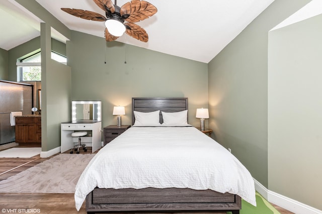 805 Harbour Pointe Way, Greenacres, FL 33413 - bedroom with vaulted ceiling, wood finished floors, baseboards, a ceiling fan, and connected bathroom