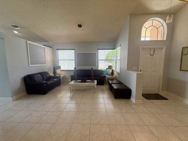 7906 Rockport Cir, Lake Worth, FL 33467 - foyer featuring a textured ceiling, healthy amount of natural light, light tile patterned floors, and baseboards
