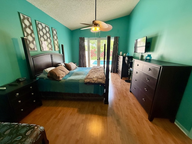 7906 Rockport Cir, Lake Worth, FL 33467 - bedroom with access to exterior, a textured ceiling, french doors, vaulted ceiling, and light wood finished floors