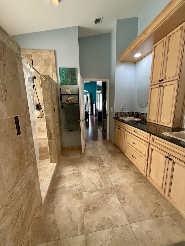 7906 Rockport Cir, Lake Worth, FL 33467 - bathroom featuring tiled shower, double vanity, and stone finish flooring