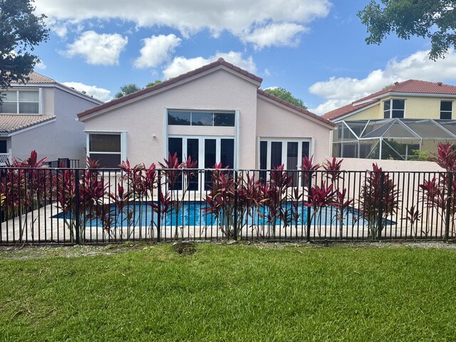 7906 Rockport Cir, Lake Worth, FL 33467 - back of property with stucco siding, french doors, a patio area, and a tiled roof