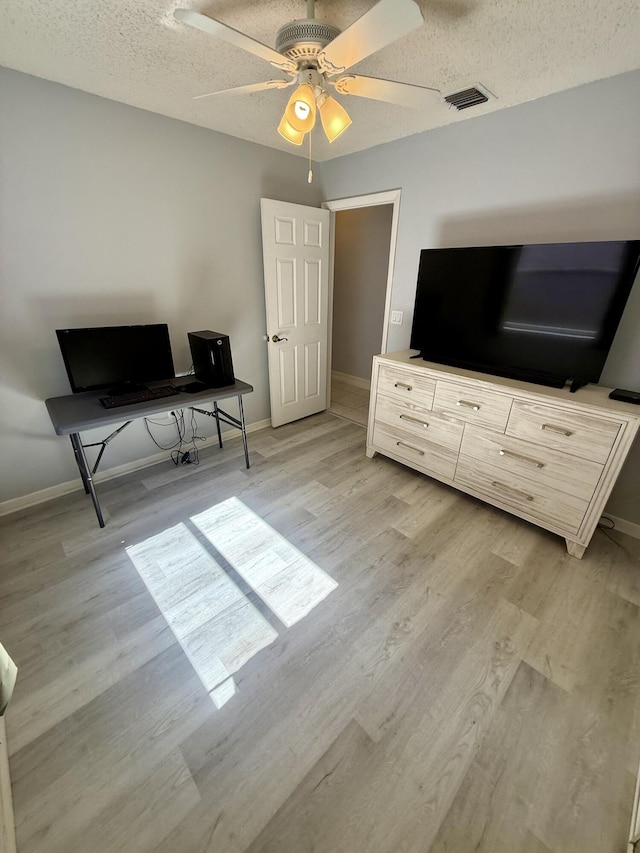 7906 Rockport Cir, Lake Worth, FL 33467 - home office with light wood-style floors, baseboards, a ceiling fan, and a textured ceiling
