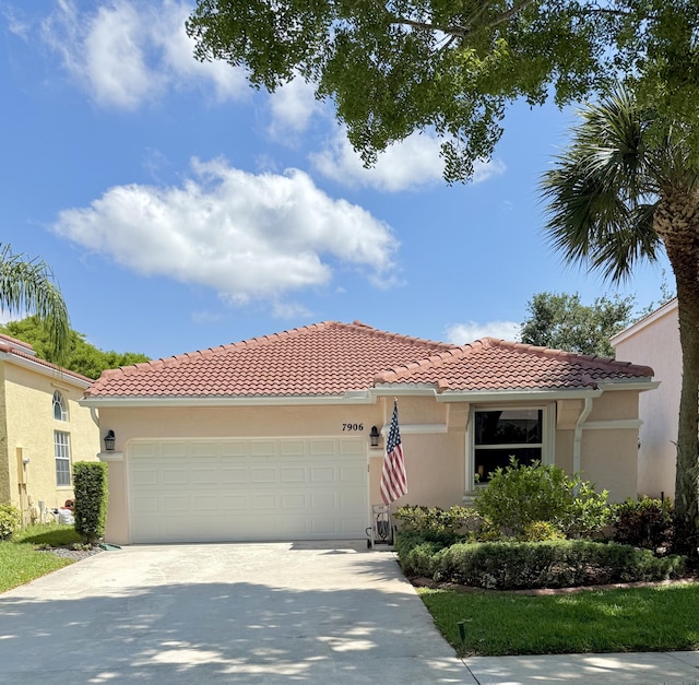 7906 Rockport Cir, Lake Worth, FL 33467 - mediterranean / spanish-style home with a garage, a tile roof, concrete driveway, and stucco siding