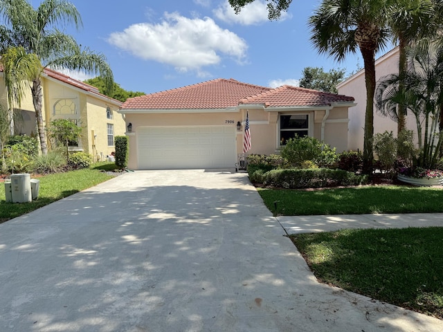 7906 Rockport Cir, Lake Worth, FL 33467 - mediterranean / spanish home featuring a garage, a tiled roof, concrete driveway, and stucco siding