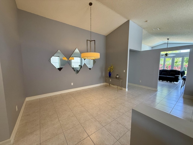 7906 Rockport Cir, Lake Worth, FL 33467 - unfurnished dining area featuring vaulted ceiling, tile patterned floors, a ceiling fan, a textured ceiling, and baseboards