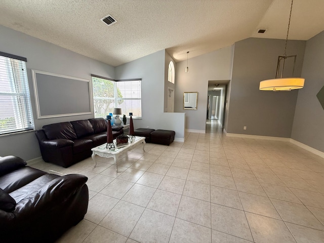 7906 Rockport Cir, Lake Worth, FL 33467 - living room featuring vaulted ceiling, light tile patterned floors, a textured ceiling, and baseboards