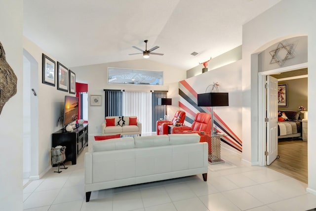 7566 San Pedro St, Boynton Beach, FL 33437 - living area with ceiling fan, vaulted ceiling, light tile patterned floors, arched walkways, and baseboards