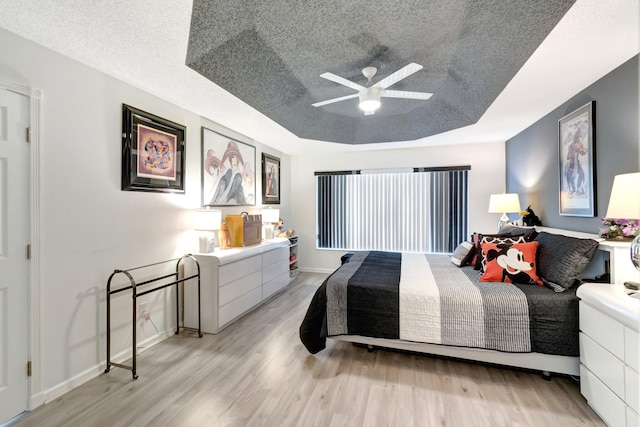 7566 San Pedro St, Boynton Beach, FL 33437 - bedroom featuring light wood-style floors, a textured ceiling, a ceiling fan, and baseboards