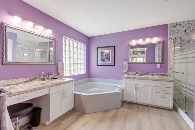 7566 San Pedro St, Boynton Beach, FL 33437 - bathroom featuring a shower stall, wood finished floors, a bath, and two vanities