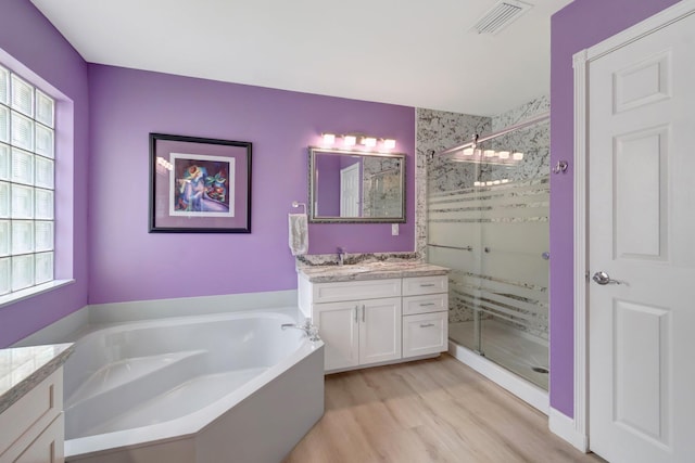 7566 San Pedro St, Boynton Beach, FL 33437 - bathroom featuring vanity, a stall shower, a garden tub, and wood finished floors