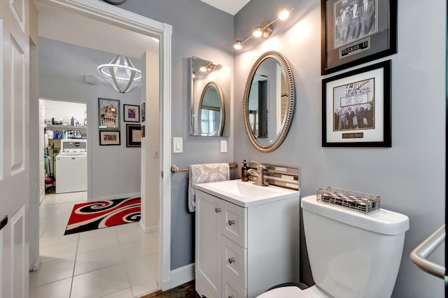 7566 San Pedro St, Boynton Beach, FL 33437 - bathroom with washer / clothes dryer, vanity, toilet, tile patterned flooring, and baseboards