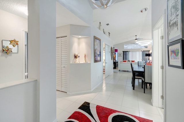 7566 San Pedro St, Boynton Beach, FL 33437 - hall with light tile patterned floors, vaulted ceiling, and baseboards