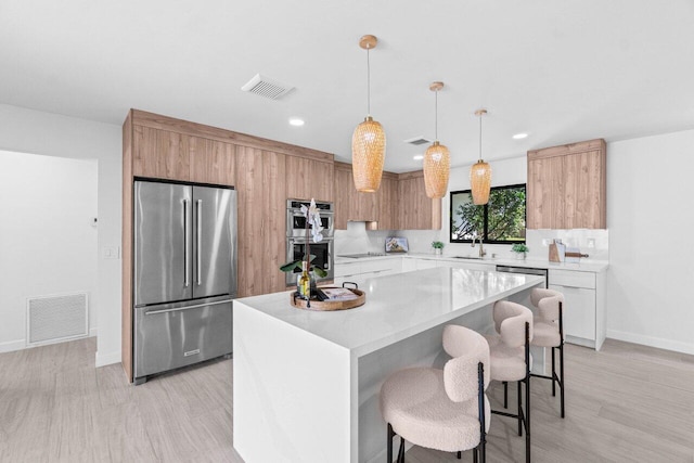812 Chapel Hill Blvd, Boynton Beach, FL 33435 - kitchen featuring stainless steel appliances, baseboards, light countertops, modern cabinets, and a breakfast bar area
