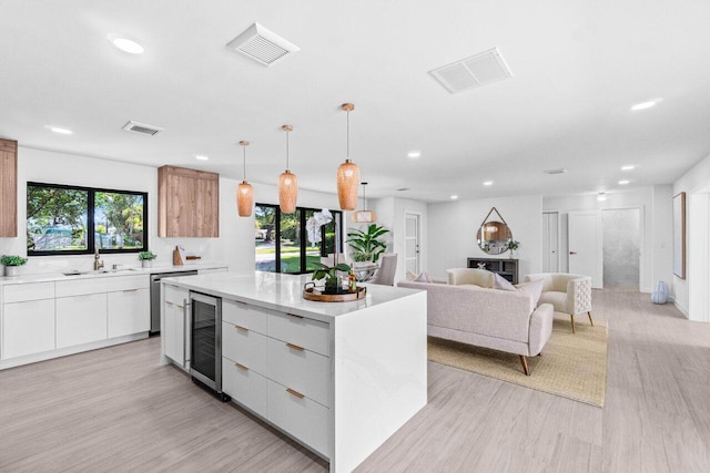 812 Chapel Hill Blvd, Boynton Beach, FL 33435 - kitchen featuring modern cabinets, wine cooler, a sink, recessed lighting, and a center island