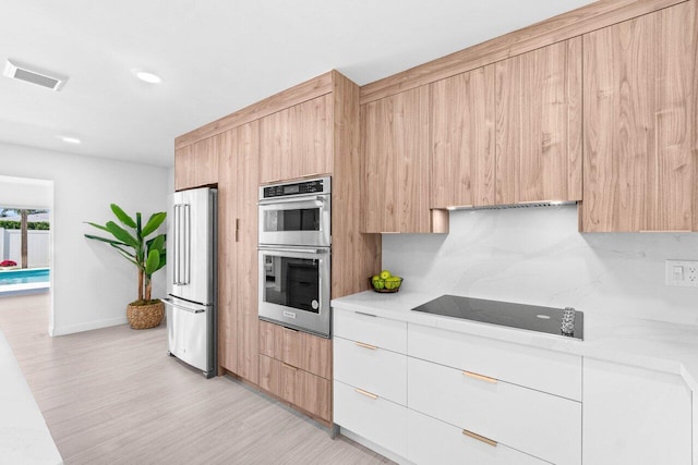 812 Chapel Hill Blvd, Boynton Beach, FL 33435 - kitchen with appliances with stainless steel finishes, modern cabinets, light countertops, backsplash, and light brown cabinets
