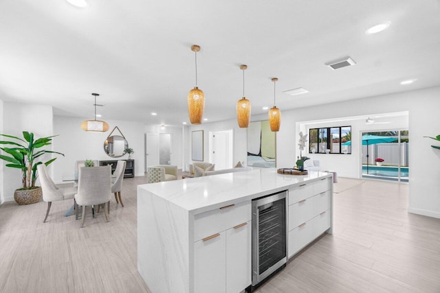 812 Chapel Hill Blvd, Boynton Beach, FL 33435 - kitchen with wine cooler, modern cabinets, open floor plan, white cabinetry, and recessed lighting
