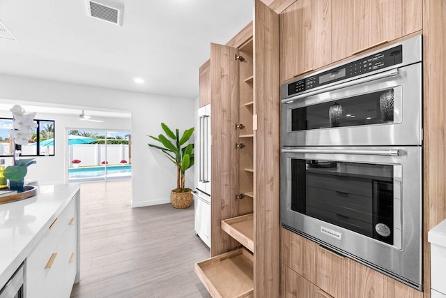 812 Chapel Hill Blvd, Boynton Beach, FL 33435 - kitchen featuring stainless steel double oven, modern cabinets, light countertops, light brown cabinets, and recessed lighting