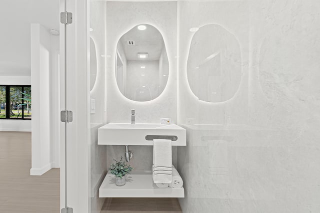 812 Chapel Hill Blvd, Boynton Beach, FL 33435 - bathroom with baseboards, a sink, and wood finished floors