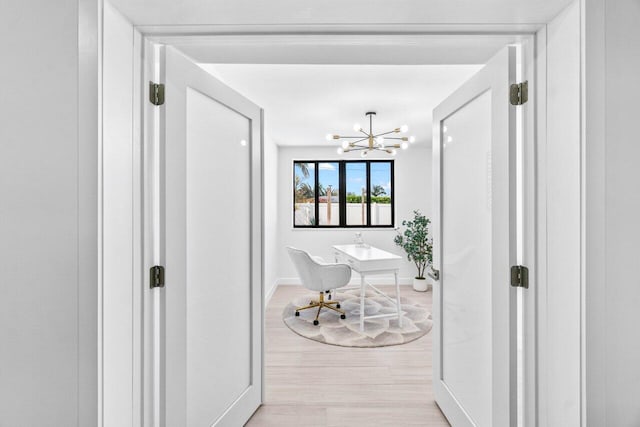812 Chapel Hill Blvd, Boynton Beach, FL 33435 - corridor featuring a chandelier, baseboards, light wood-style flooring, and an office area