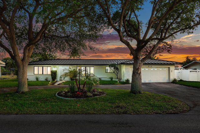 812 Chapel Hill Blvd, Boynton Beach, FL 33435 - mid-century modern home with a standing seam roof, stucco siding, driveway, and an attached garage