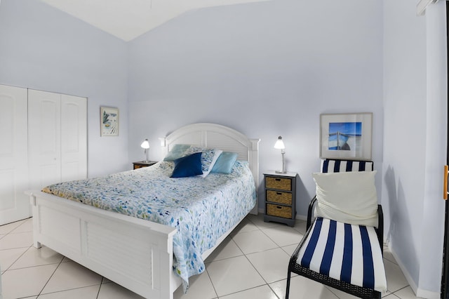 5451 Verona Dr Unit M, Boynton Beach, FL 33437 - bedroom featuring light tile patterned floors, high vaulted ceiling, a closet, and baseboards