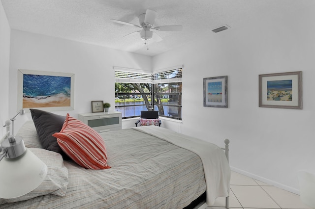 5451 Verona Dr Unit M, Boynton Beach, FL 33437 - bedroom with a water view, a textured ceiling, light tile patterned floors, ceiling fan, and baseboards