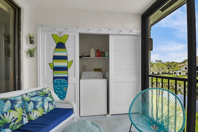 5451 Verona Dr Unit M, Boynton Beach, FL 33437 - laundry area featuring washer / dryer, healthy amount of natural light, and light tile patterned flooring