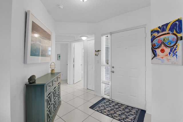 5451 Verona Dr Unit M, Boynton Beach, FL 33437 - foyer entrance with light tile patterned flooring and a textured ceiling