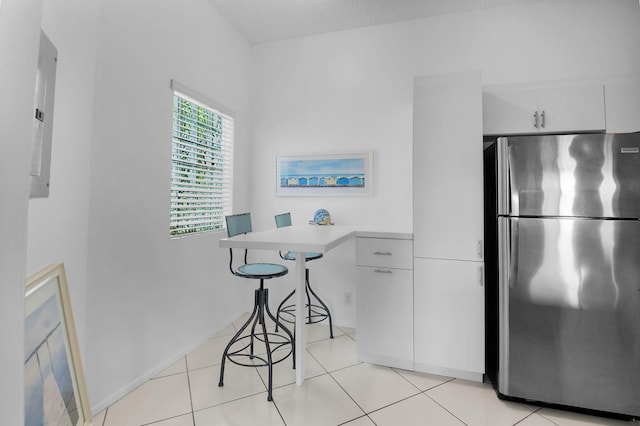 5451 Verona Dr Unit M, Boynton Beach, FL 33437 - kitchen with freestanding refrigerator, white cabinets, light countertops, and light tile patterned floors