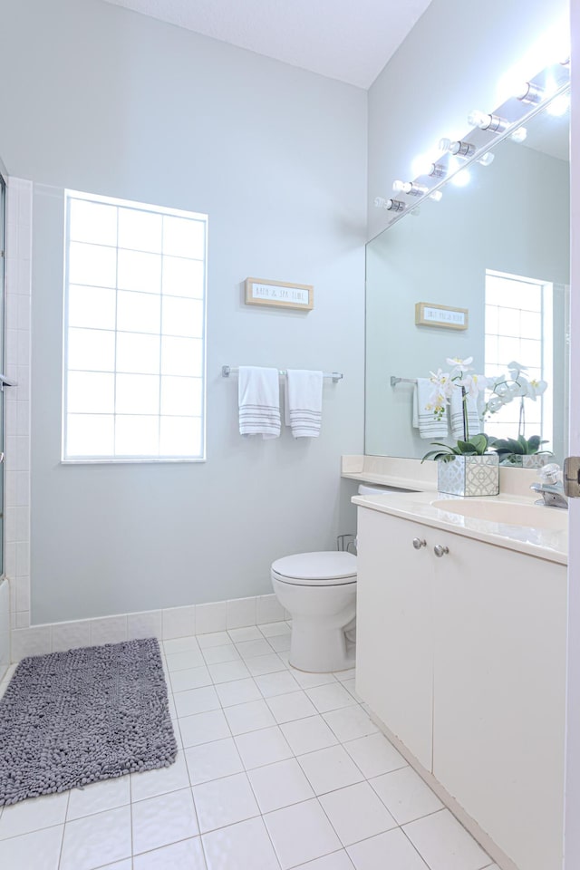13664 Kiltie Ct, Delray Beach, FL 33446 - bathroom featuring vanity, toilet, tile patterned floors, and healthy amount of natural light