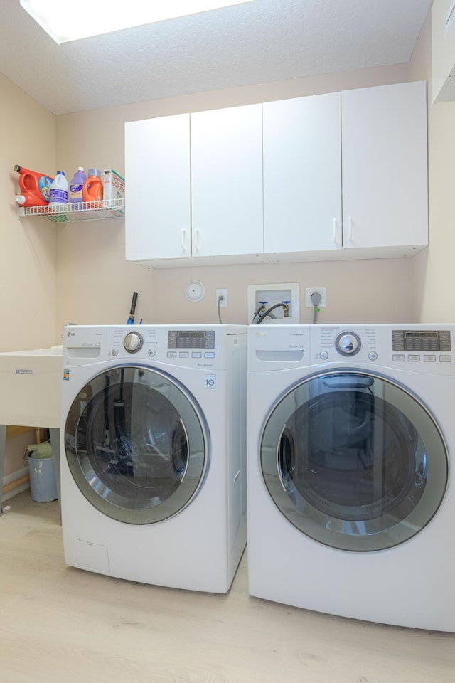 13664 Kiltie Ct, Delray Beach, FL 33446 - laundry area featuring light wood-style flooring, washer and dryer, and cabinet space