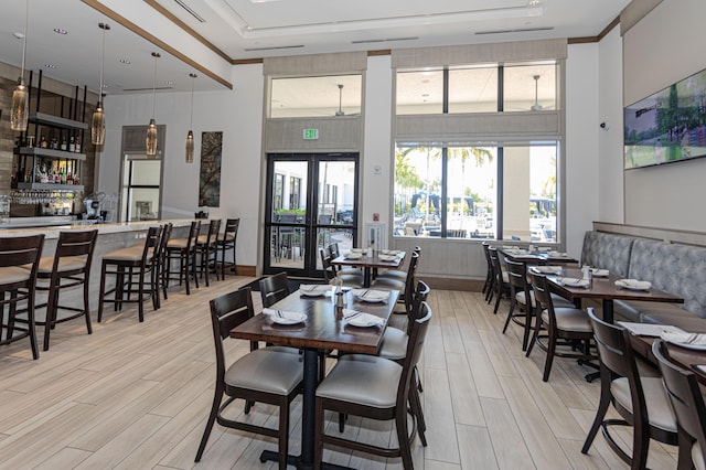 13664 Kiltie Ct, Delray Beach, FL 33446 - dining space with light wood-type flooring, a high ceiling, a community bar, and a raised ceiling