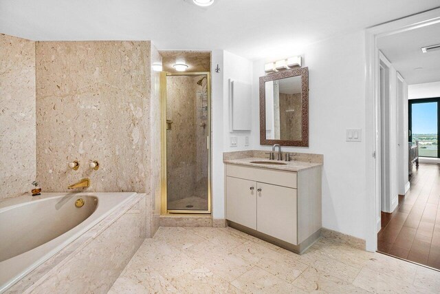 1500 S Ocean Blvd Unit 804, Boca Raton, FL 33432 - bathroom featuring a stall shower, vanity, baseboards, and a bath