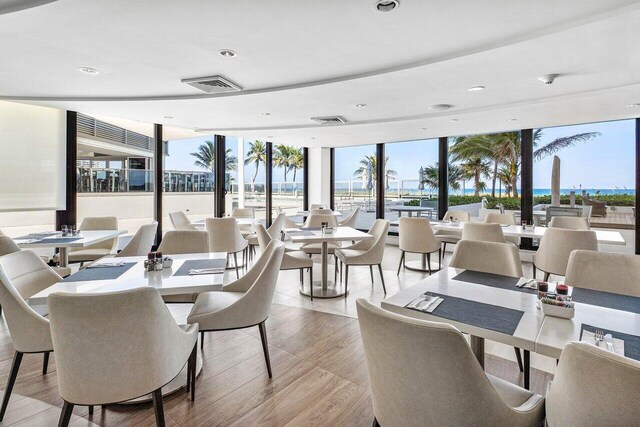 1500 S Ocean Blvd Unit 804, Boca Raton, FL 33432 - dining space featuring expansive windows, plenty of natural light, recessed lighting, a water view, and light wood finished floors