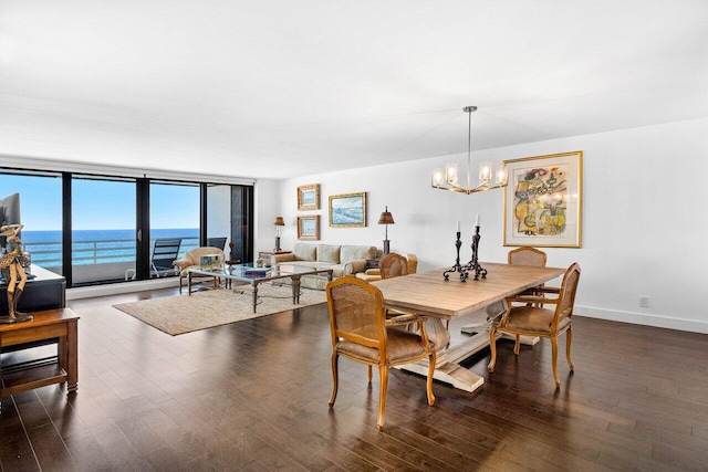 1500 S Ocean Blvd Unit 804, Boca Raton, FL 33432 - dining area with a chandelier, dark wood-style flooring, baseboards, and a water view