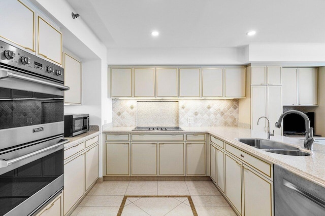 1500 S Ocean Blvd Unit 804, Boca Raton, FL 33432 - kitchen featuring appliances with stainless steel finishes, a sink, cream cabinets, decorative backsplash, and recessed lighting