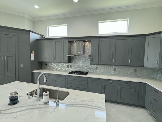 4662 Estates Cir, Westlake, FL 33470 - kitchen featuring wall chimney exhaust hood, stainless steel gas stovetop, light stone countertops, gray cabinets, and backsplash