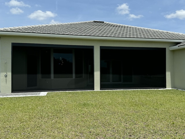 4662 Estates Cir, Westlake, FL 33470 - back of property featuring a yard, a tile roof, and stucco siding